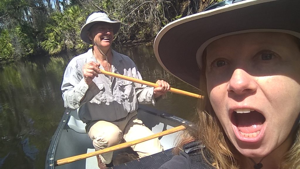 A man rowing a boat and a woman with her mouth open, for no reason.